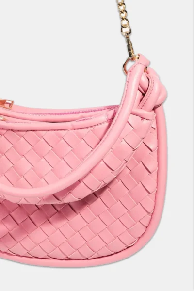 a pink purse with a braided strap